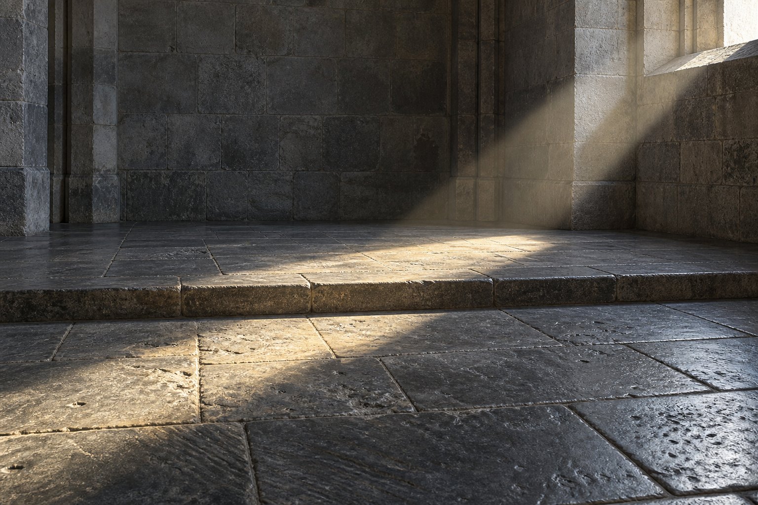 An open flagstone floor with a shallow step and a single shaft of daylight falling across it from a high window