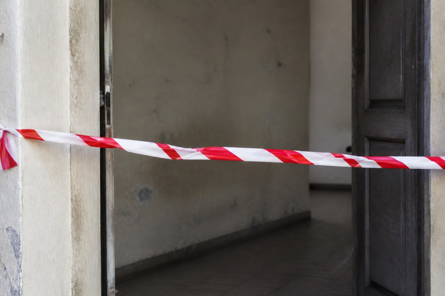 Hazard tape stretched across an open doorway