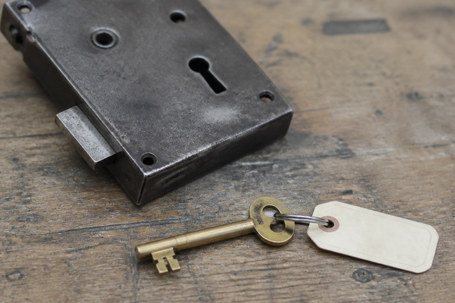 A labelled brass key beside a lock it plainly does not fit