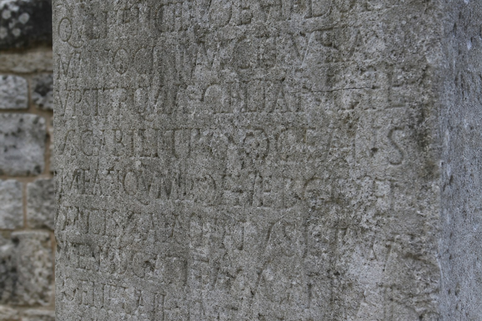 A stone slab densely covered in deeply cut Roman capital lettering