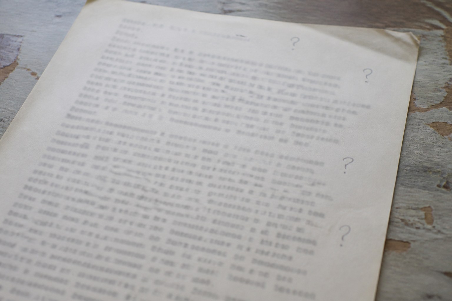 A typed page carrying several pencilled question marks in the margin