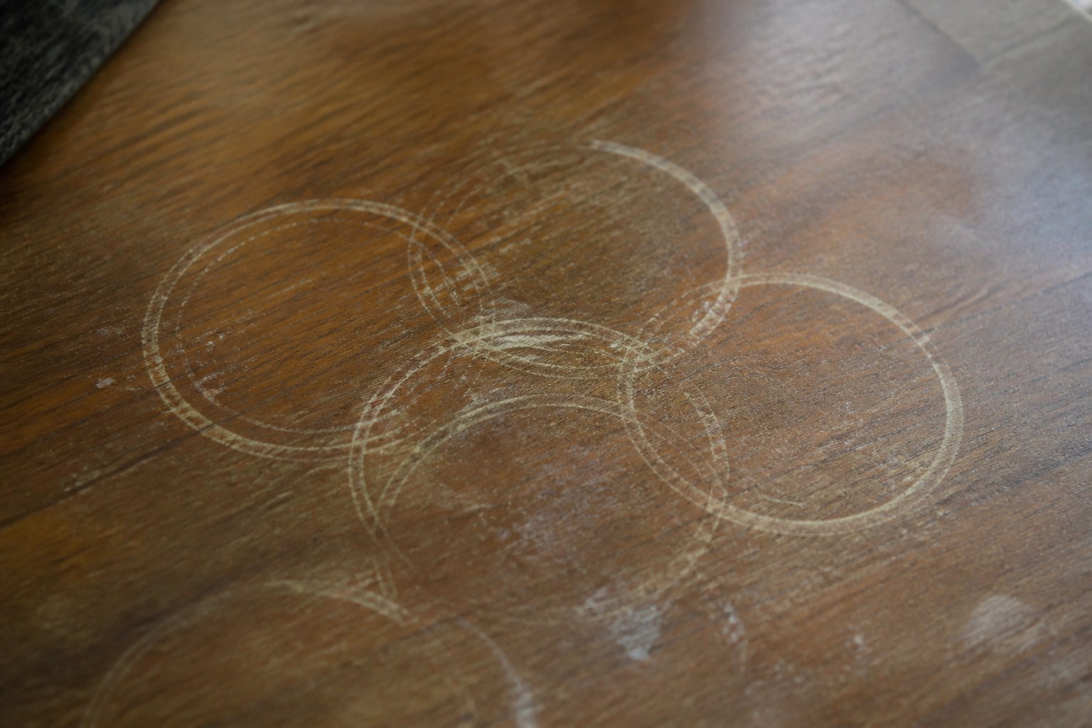 Several overlapping cup rings dried into a wooden table
