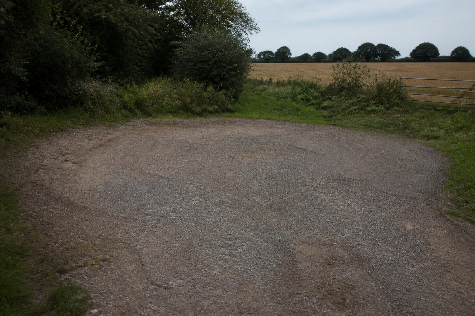 A turning circle worn into gravel at the end of a track with no exit beyond