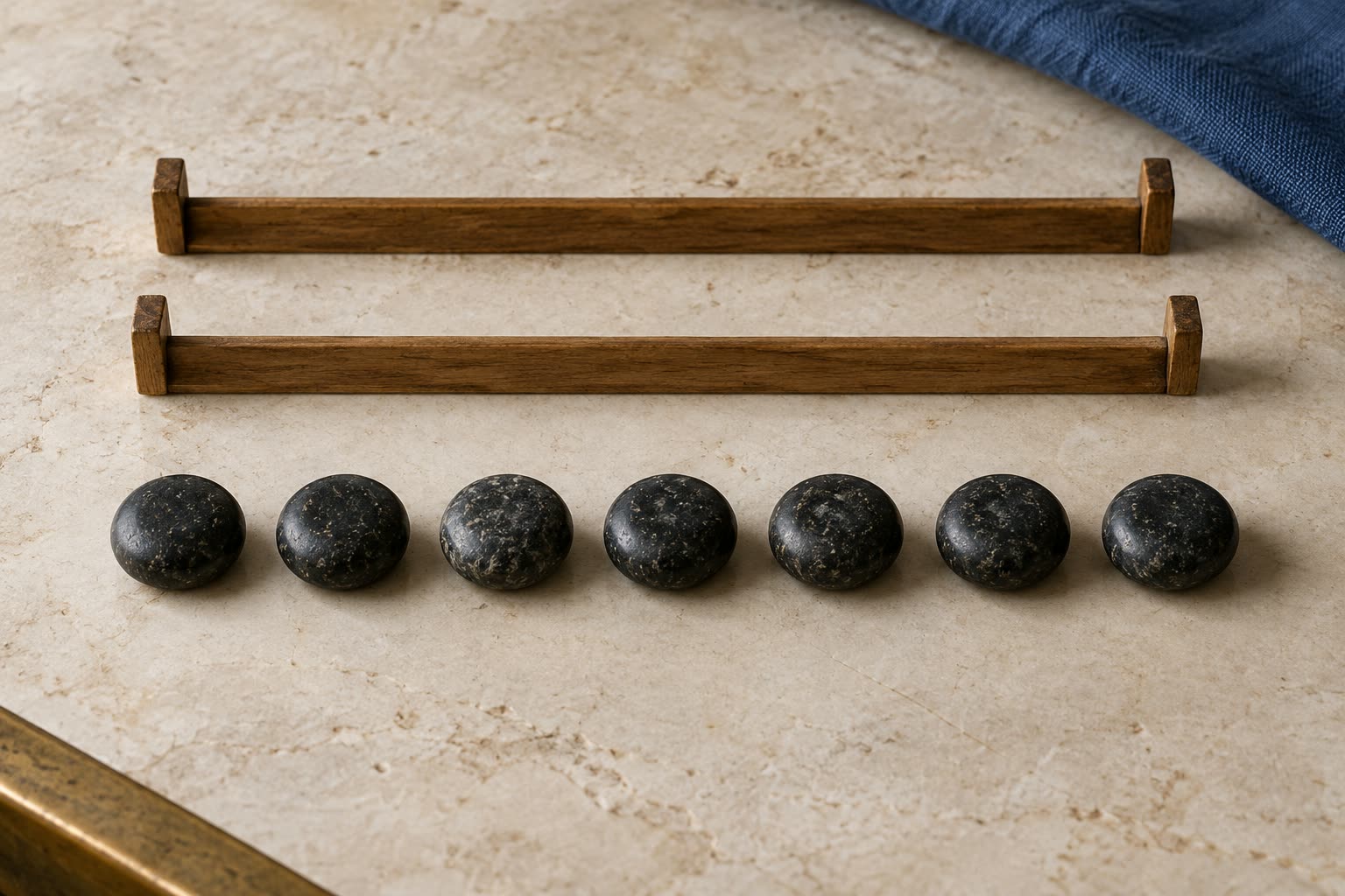 Seven dark stone counters in one row beneath two empty wooden dividers