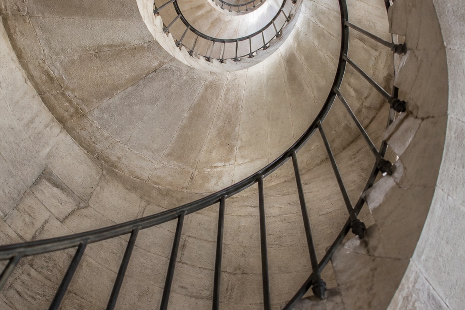 A stone spiral staircase seen from directly below