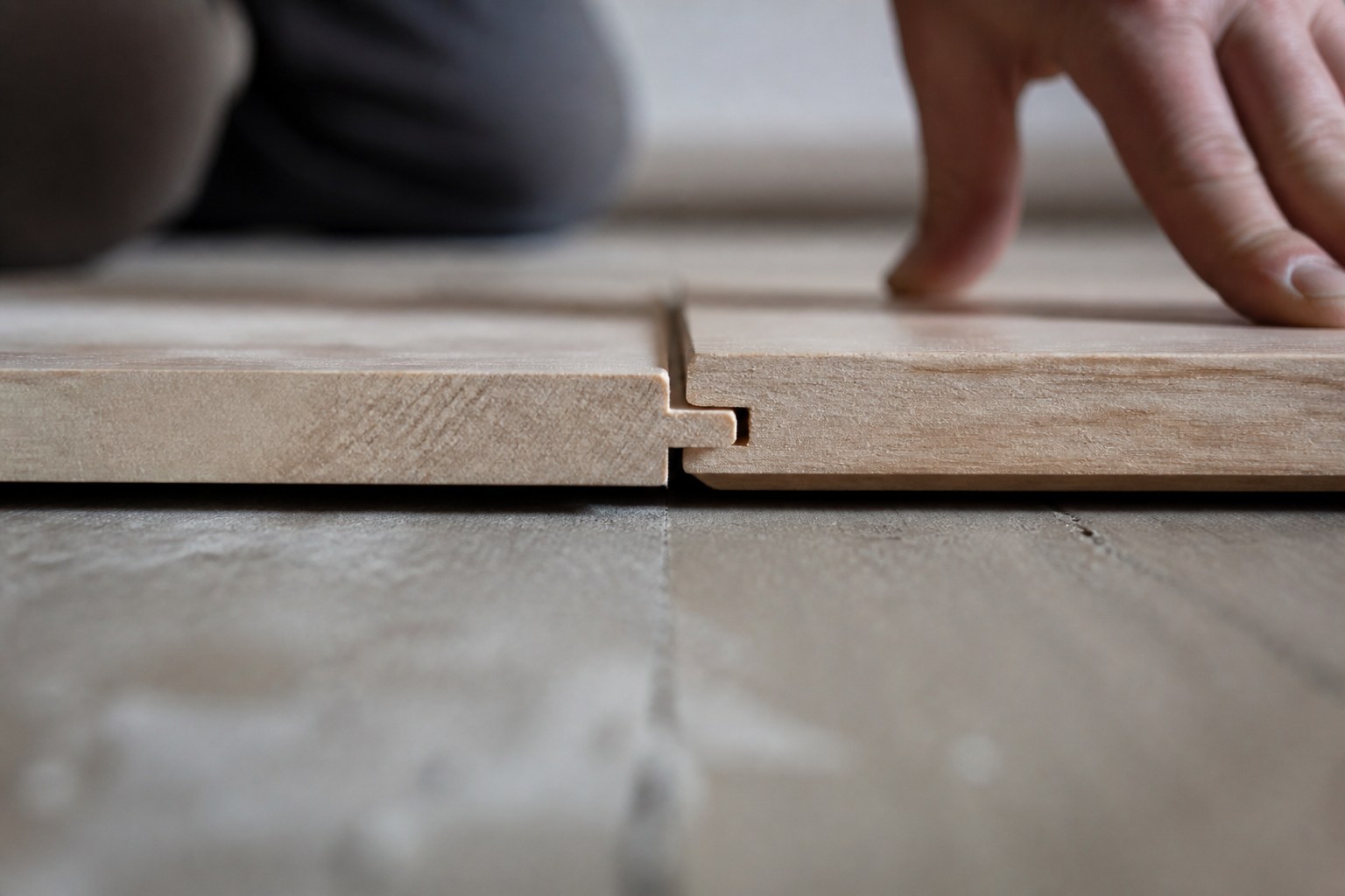 A tongue and groove board being pushed home into its neighbour