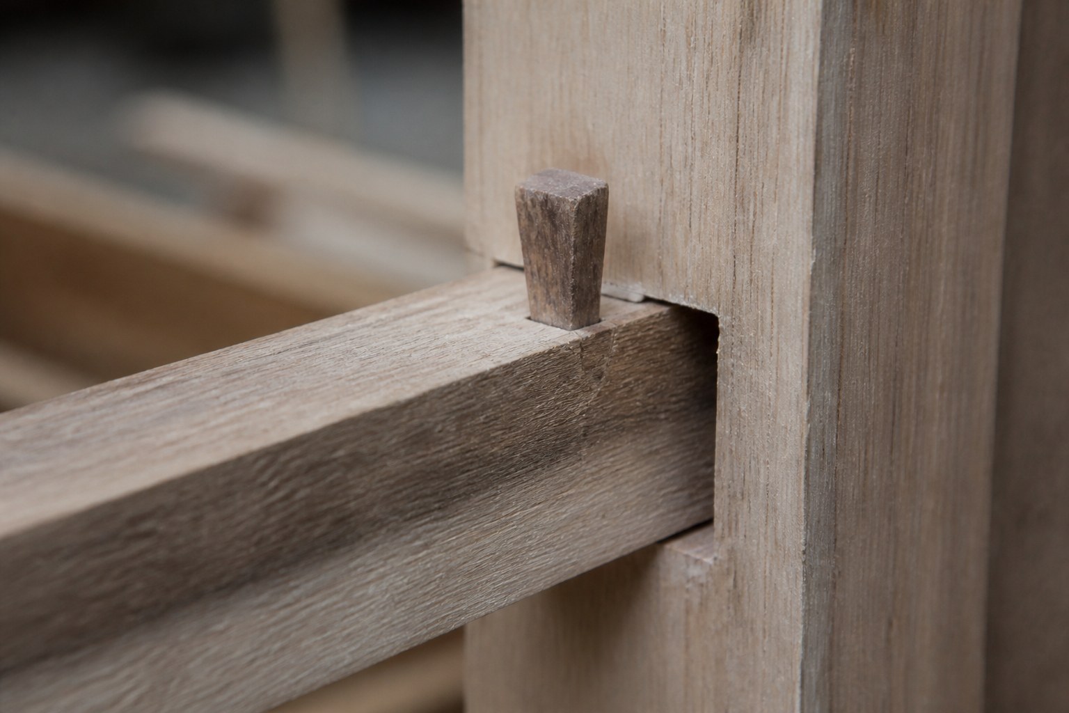 A wooden wedge driven into a sawn tenon to lock it