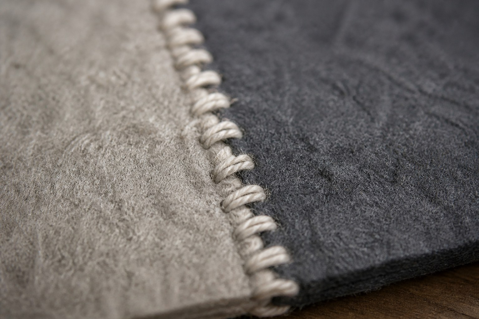 A blanket stitched edge worked in wool along two joined pieces of felt