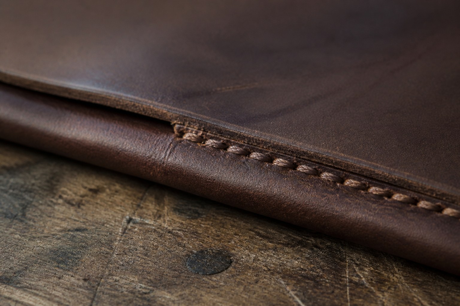 A saddle stitched seam in thick vegetable tanned leather