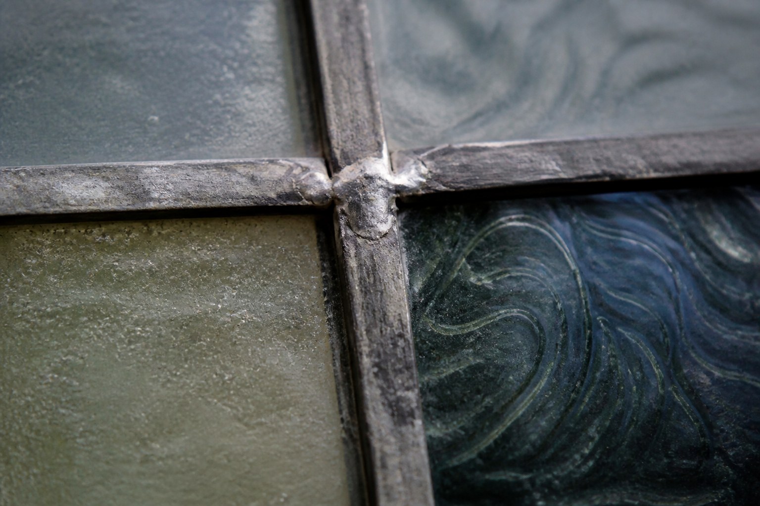 Lead came soldered at the meeting of two pieces of stained glass